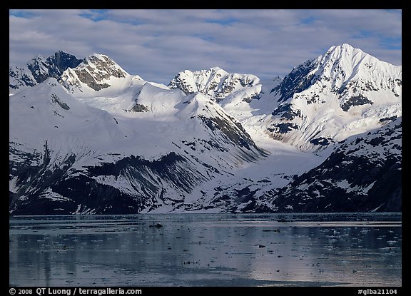 Coastal mountains with glacier dropping into icy fjord. Glacier Bay National Park (color)