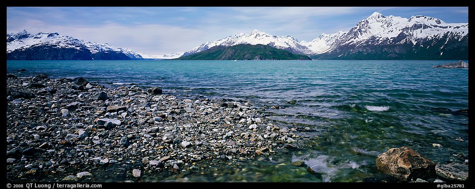 Snowy mountains rising above water. Glacier Bay National Park, Alaska, USA.