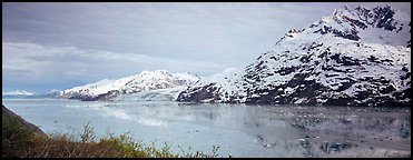 Snowy mountains rising above fjord. Glacier Bay National Park (Panoramic color)