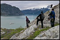 Film crew carrying a motion picture camera down rocky slopes. Glacier Bay National Park ( color)
