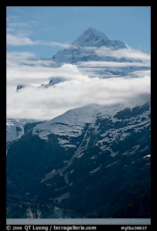 Pointed mountain with clouds hanging below. Glacier Bay National Park, Alaska, USA.