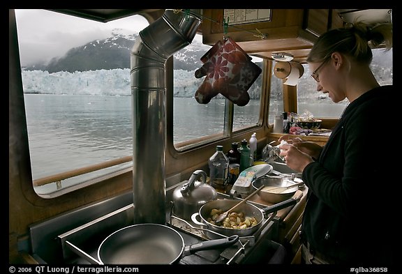 Woman preparing a breakfast aboard small tour boat. Glacier Bay National Park, Alaska, USA.