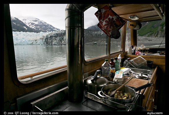 Breakfast potatoes in a small boat moored in front of glacier. Glacier Bay National Park, Alaska, USA.