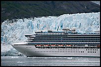 Cruise ship dwarfed by the face of Margerie Glacier. Glacier Bay National Park, Alaska, USA. (color)