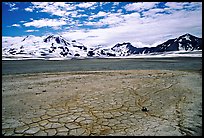 The desert-like floor of the Valley of Ten Thousand smokes is surrounded by snow-covered peaks such as Mt Meigeck. Katmai National Park, Alaska, USA.
