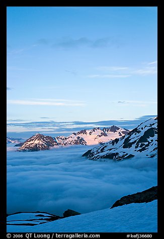 Snowy mountains and see of clouds at sunset. Kenai Fjords National Park, Alaska, USA.