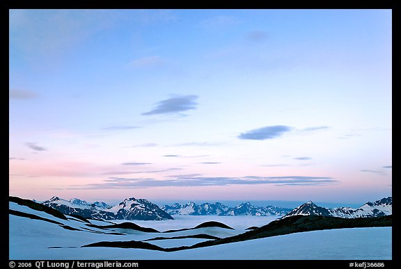 Pastel sky, mountain ranges and sea of clouds at dusk. Kenai Fjords National Park, Alaska, USA.