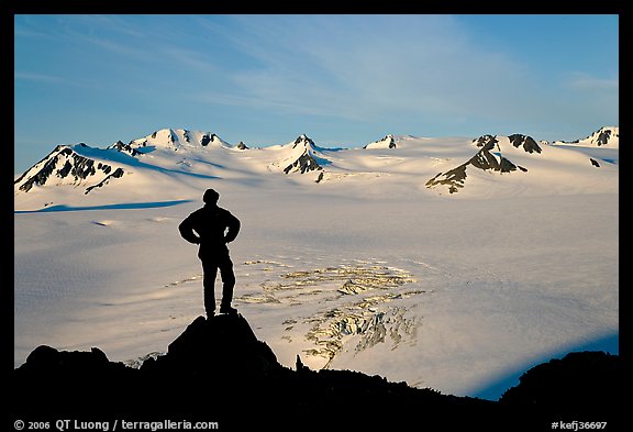 Man standing on overlook above Harding ice field, early morning. Kenai Fjords National Park, Alaska, USA.