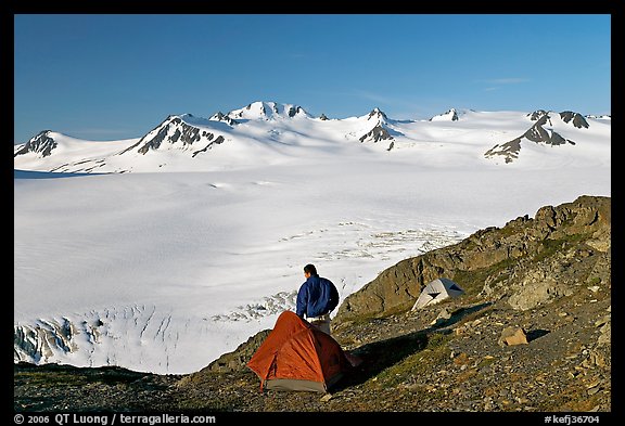 Tent and backpacker above the Harding icefield. Kenai Fjords National Park, Alaska, USA.