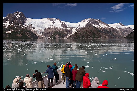 People looking at glaciers as boat crosses ice-chocked waters, Northwestern Fjord. Kenai Fjords National Park (color)