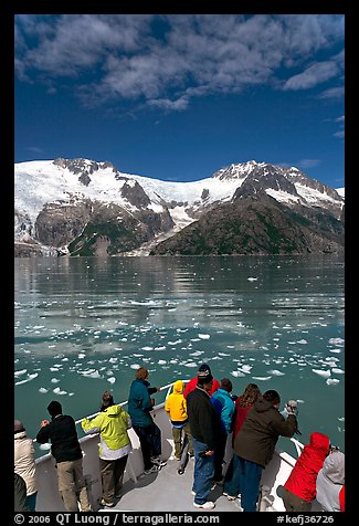People looking as tour boat slows down for iceberg, Northwestern Fjord. Kenai Fjords National Park, Alaska, USA.