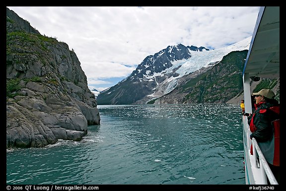 Passenger on small tour boat, island and glacier, Northwestern Fjord. Kenai Fjords National Park, Alaska, USA.
