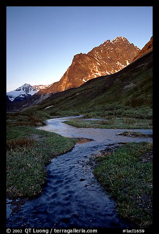 Stream on plain  below the Telaquana Mountains, late afternoon. Lake Clark National Park, Alaska, USA.