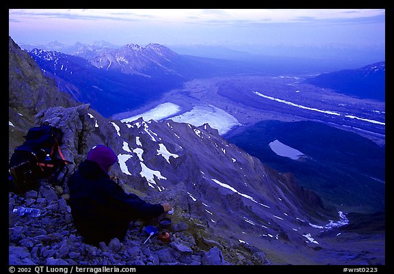 Mountaineer looking down from Mt Donoho. Wrangell-St Elias National Park, Alaska, USA.