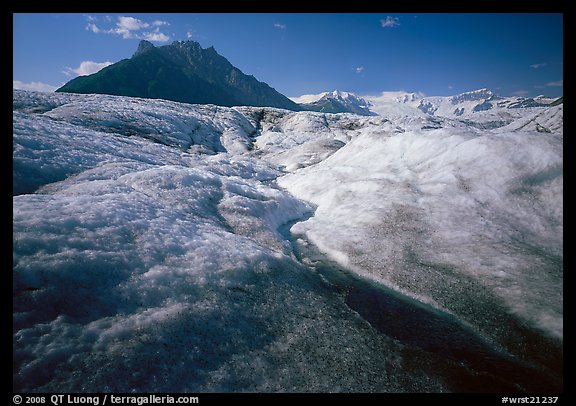 Stream running on surface of Root Glacier and Donoho Peak. Wrangell-St Elias National Park, Alaska, USA.