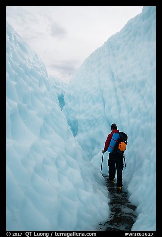 Hiker in narrow canyon, Root glacier. Wrangell-St Elias National Park (color)