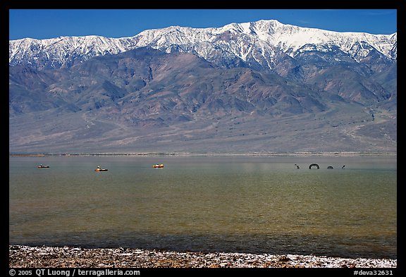Kayakers padding towards the Loch Ness Monster in Manly Lake, below Telescope Peak. Death Valley National Park (color)