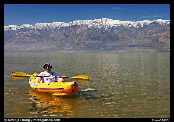 Kayaker padding ephemeral Manly Lake. Death Valley National Park, California, USA.