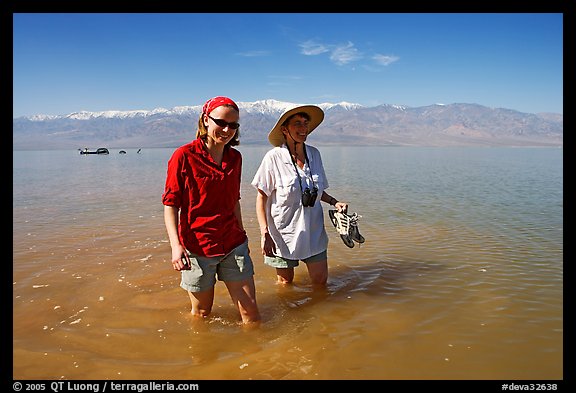 Women wading in the knee-deep seasonal lake. Death Valley National Park, California, USA.