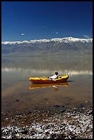 Salt formations, kayaker, and Panamint range. Death Valley National Park, California, USA.
