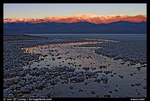 Salt pool and sunrise over the Panamints. Death Valley National Park, California, USA.