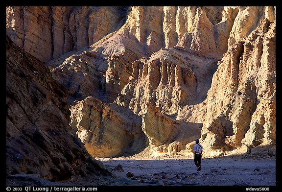 Hikers surrounded by tall walls in Golden Canyon. Death Valley National Park, California, USA.