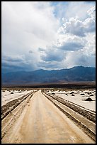 Road crossing Salt Pan. Death Valley National Park, California, USA.