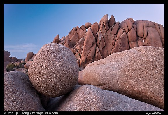 Round granite boulder and triangular rocks, dusk. Joshua Tree National Park, California, USA.