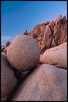 Spherical granite boulder and angular rocks, twilight. Joshua Tree National Park, California, USA.