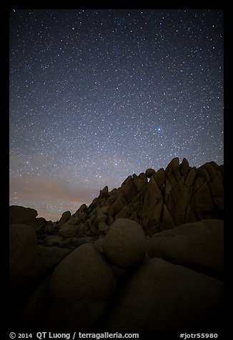 Marble rocks under clear starry sky. Joshua Tree National Park, California, USA.
