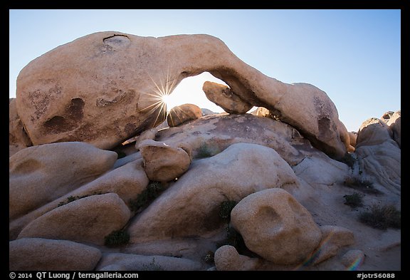 Boulders, Arch Rock, and sun. Joshua Tree National Park, California, USA.