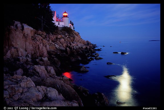 Bass Harbor lighthouse by night with moon reflection in ocean. Acadia National Park (color)