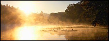 Sun rising above misty lake at dawn. Cuyahoga Valley National Park (Panoramic color)