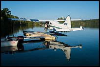 Pilot opening door at floatplane dock. Isle Royale National Park ( color)