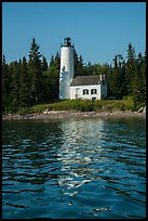 Rock Harbor Lighthouse with tree shadaow and reflection. Isle Royale National Park, Michigan, USA.