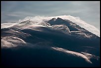 Cloudcap over backlit Mt Scott summit. Crater Lake National Park, Oregon, USA.