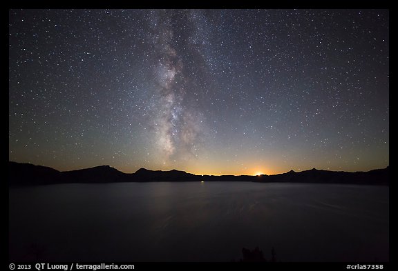 Milky Way and Crater Lake with setting moon. Crater Lake National Park, Oregon, USA.
