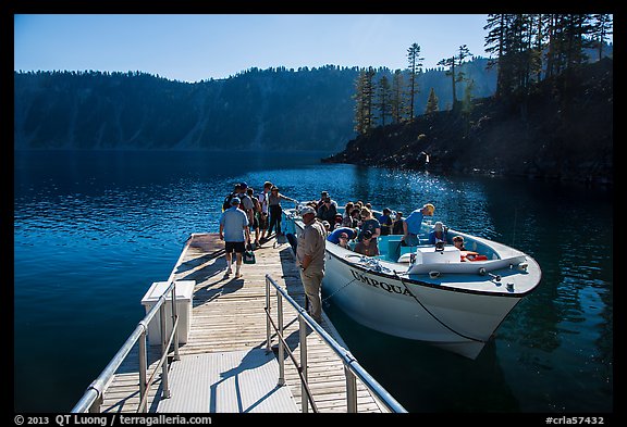 Visitors embark on tour boat at Wizard Island boat dock. Crater Lake National Park (color)