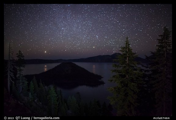 Trees, Wizard Island and lake at night. Crater Lake National Park, Oregon, USA.