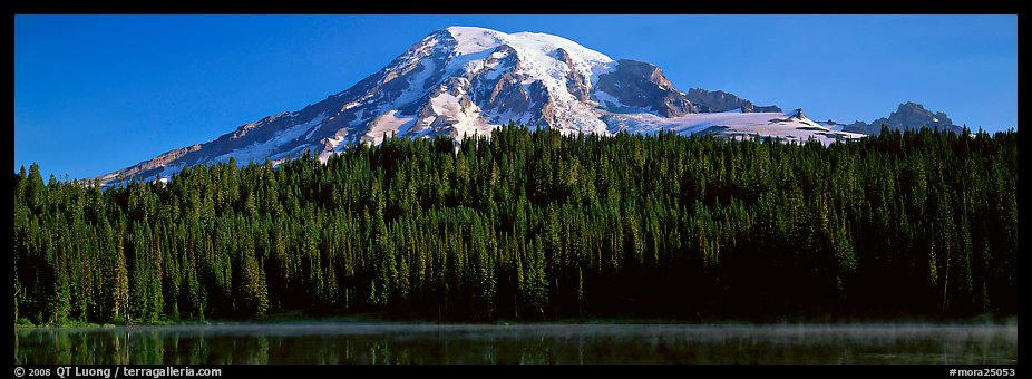 Mount Rainier raising above forest and lake. Mount Rainier National Park, Washington, USA.