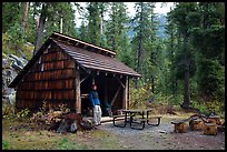 Hiker at high Bridge campground shelter, North Cascades National Park. Washington, USA.