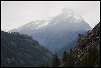 Snow-capped jagged peak in clouds, North Cascades National Park. Washington, USA.