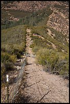 Boundary fence on steep hillside. Pinnacles National Park, California, USA.