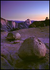 Glacial erratic boulders and Half Dome, Olmsted Point, dusk. Yosemite National Park, California, USA.