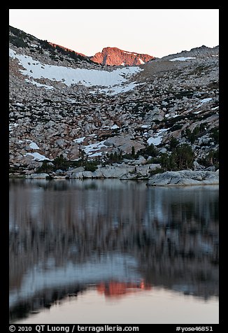 Last light on peak reflected in Vogelsang Lake. Yosemite National Park, California, USA.