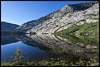 Peaks reflected in mirror-like waters, Merced Lake. Yosemite National Park, California, USA.