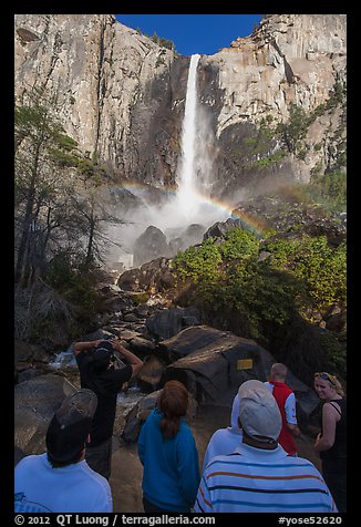 Tourists standing below Bridalvail Fall. Yosemite National Park, California, USA.
