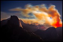 Half-Dome, fire and smoke at night. Yosemite National Park, California, USA.