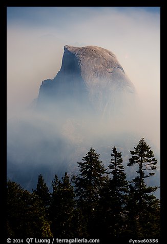 Half-Dome emerging from smoke at night. Yosemite National Park, California, USA.