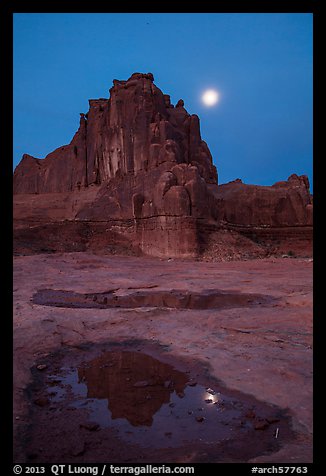 Courthouse tower and moon at night. Arches National Park, Utah, USA.